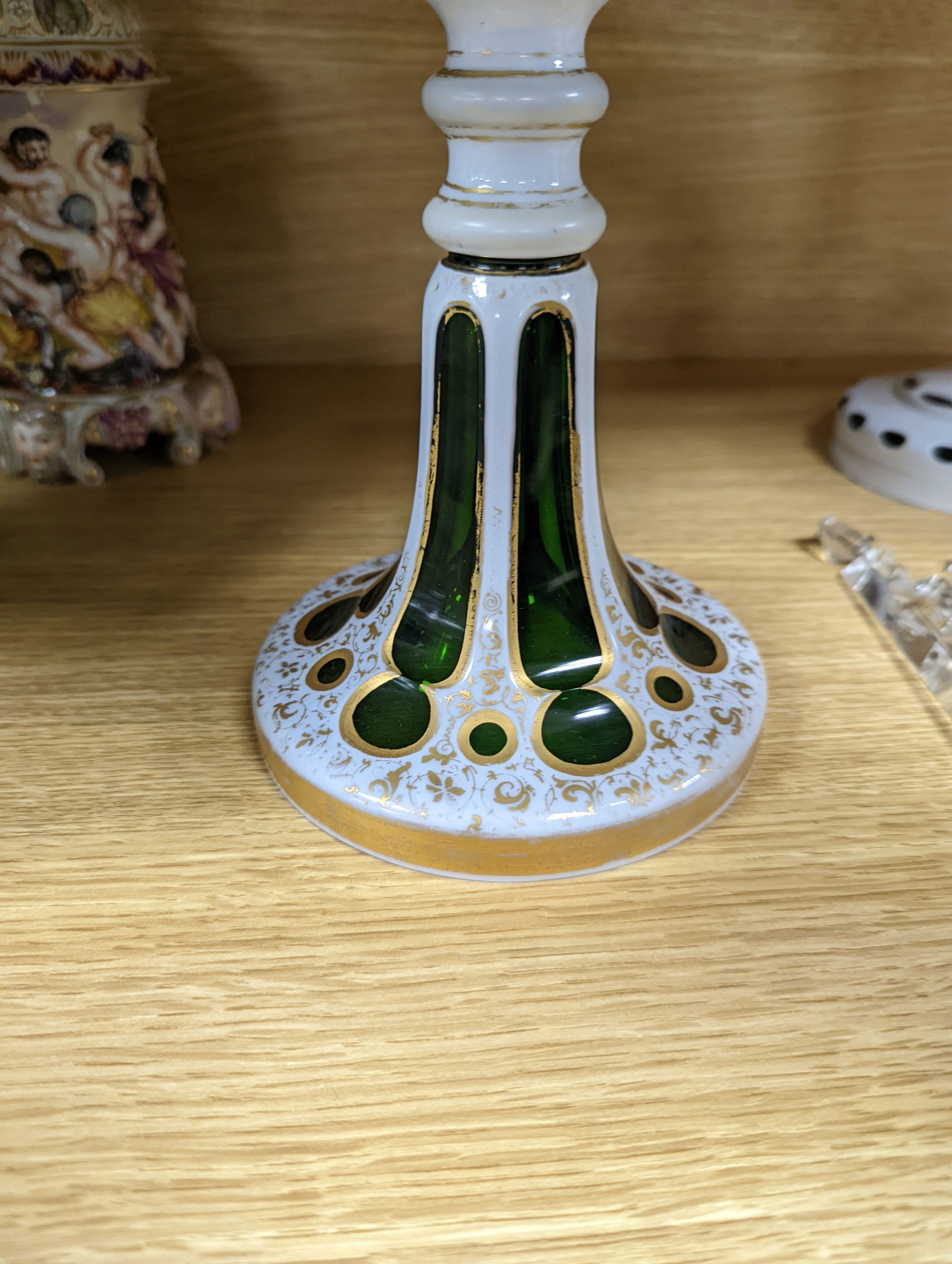 A 19th century overlaid green glass comport, 24cm high, and a similar table lustre